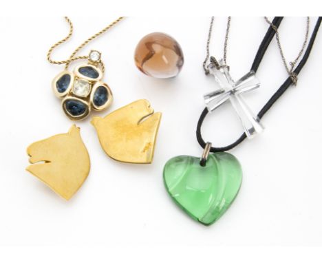Five modern items of designer jewellery, including a Lalique amber glass ring, a green Baccarat glass heart pendant, a Christ