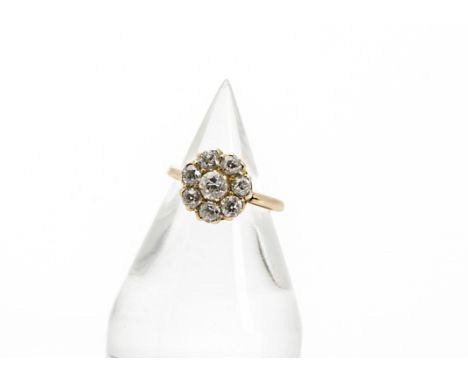 An Edwardian 18ct gold and diamond cluster ring, the flower head tablet set with eight old cuts totalling approx 1.1ct, 2.8g 