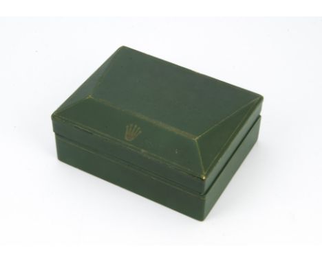 A vintage Rolex "Coffin" watch box, in green with embossed logo to shaped lid, some dents and scuffs 