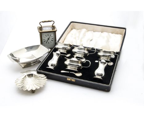 A cased George V period silver double cruet set by Adie Bros, comprising a pair of mustards, salts and peppers, with spoons, 
