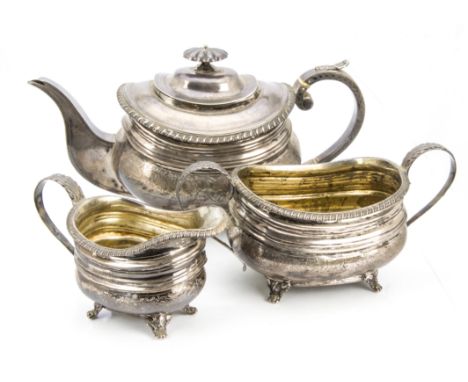 A Victorian Scottish silver three piece tea set by JR, squat bombe form on scroll and paw supports with engraved floral motif