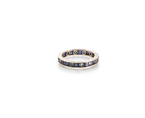 A vintage gold and gem set full eternity ring, having blue and clear stones, 1.6g and size J 