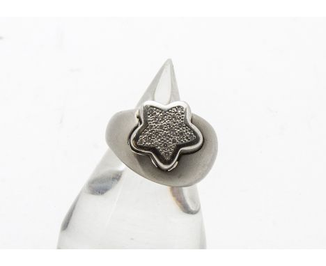 A modern white gold and diamond dress ring, the thick and heavy satin finished mount having a star set with small eight cuts,