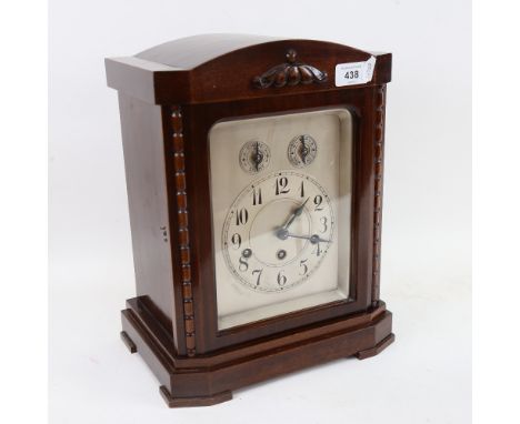 A Junghans oak 8-day chiming mantel clock, silvered dial with painted Arabic numerals and stained case, with movement chiming