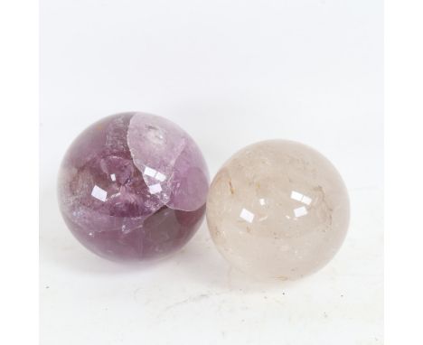 A polished amethyst sphere crystal ball, and a smaller rock crystal example, largest diameter 10cm (2) 