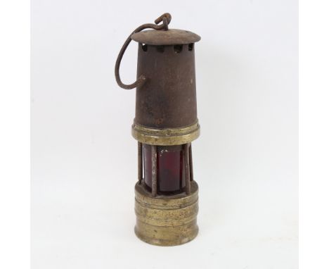 A brass miner's lamp with cranberry glass shade, height 27cm 