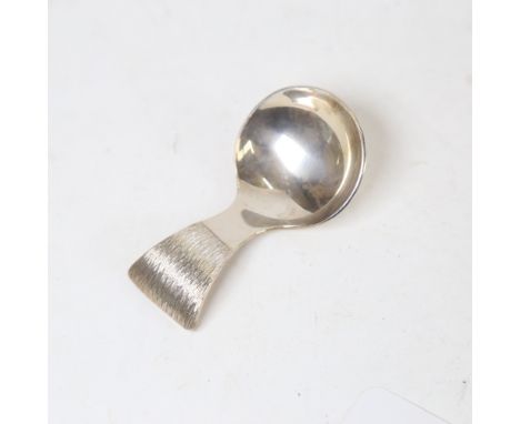 An Elizabeth II silver tea caddy spoon, textured handle with planished bowl, maker's marks JA, hallmarks London 1976, length 