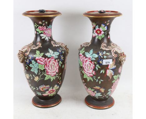 A pair of 19th century porcelain vases and covers, with enamel decoration and gilded ram's head handles, height 42cm 