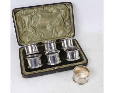 An Edwardian cased set of 6 silver napkin rings, by Walker &amp; Hall, hallmarks Chester 1906, and another silver ring, 5.4oz
