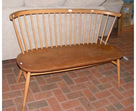 An Ercol two seater love seat with elm seat and stick back - 120cms long with original sticker