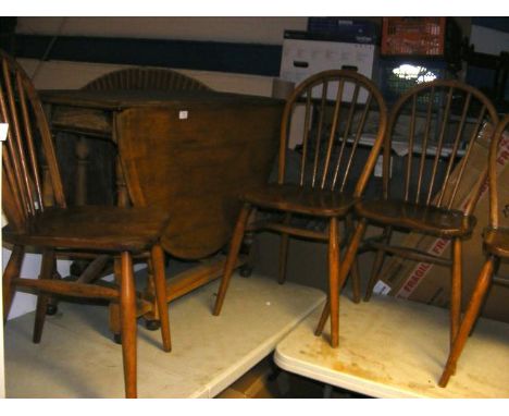 An oak gate-leg table, together with four spindle back chairs 