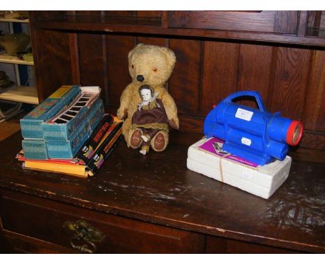 A vintage Chad Valley 'Give a Show' projector, together with slides, a straw filled teddy bear, porcelain doll etc.