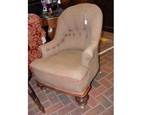 An antique button back easy chair
