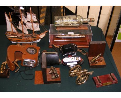 A quantity of vintage cameras including Kodak Brownie 8mm movie camera II, together with cannon book ends and ships models