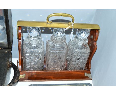 A LATE VICTORIAN BETTJEMANN'S PATENT 'THE TANTALUS', brass carrying bracket, walnut frame with plated mounts, one decanter no