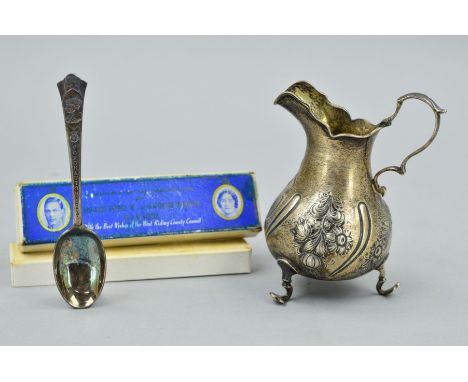 AN EARLY VICTORIAN SILVER CREAM JUG AND A MAPPIN & WEBB CORONATION SPOON, the jug of bellied form with pad feet and high arch