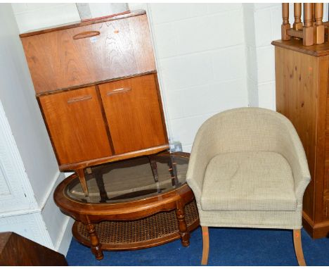 A SLIM TEAK BUREAU, a modern oval coffee table, with glass top and rattan undershelf and a modern commode/armchair (3)