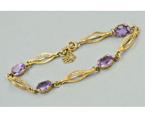 AN AMETHYST BRACELET, designed as four oval amethysts interspaced by openwork, billow shaped, textured links to the spring re
