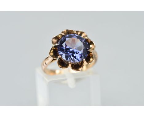 A GEM RING, the circular synthetic colour change sapphire, claw set in a floral design mount, ring size K1/2, approximate wei