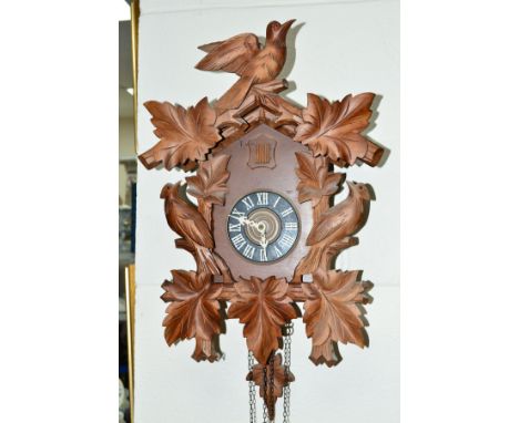 A REPRODUCTION CUCKOO CLOCK, with pendulum 