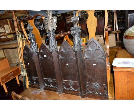 AN EARLY 20TH CENTURY OAK FOUR SECTION ECCLESIASTICAL SCREEN/PANEL, with later shelf