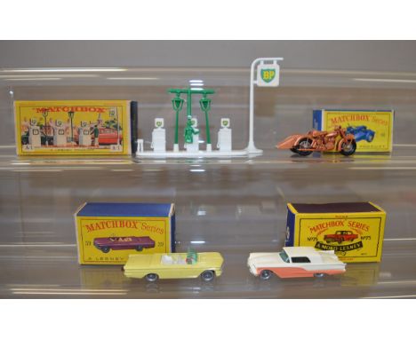 Three boxed Matchbox diecast models from the '1-75' range, including 39b Pontiac Convertible in yellow with crimson base, SPW