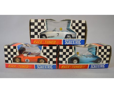 Three Scalextric Race Tuned slot cars: C79 Offenhauser Front Engine Grand Prix in blue; C11 Super Electra in orange, racing n