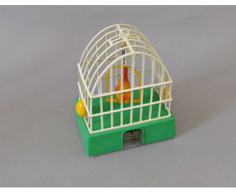 Airfix clockwork plastic caged bird. Cage base is green with integral key, marked 'An Airfix Product Made in England' in cent