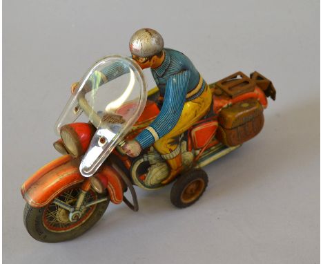 An unboxed vintage clockwork tinplate early 1950s friction driven Motorcycle  with Rider 'TCO 598', 28cm long, produced in Ge