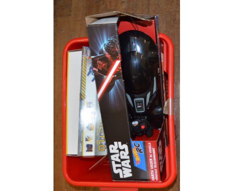 Four boxed remote control vehicles including a Hot Wheels 'Darth Vader Vehicle', a Robot Beetle, a plastic battery operated C