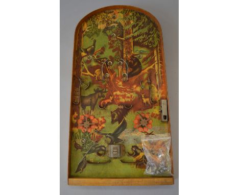 A vintage unboxed wooden bagatelle game, the playing board featuring a scene of various animals in a forest, complete with fi