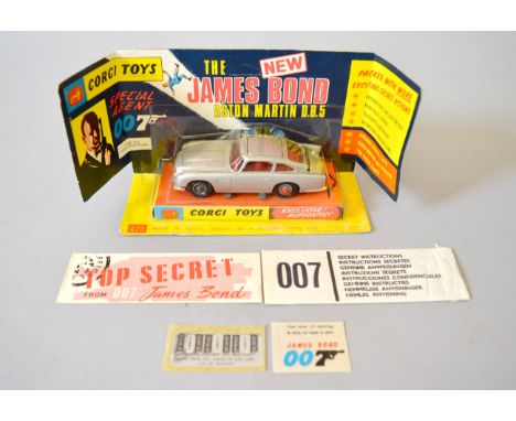 Corgi 270 James Bond 007 Aston Martin DB5 - silver with red interior and tyre slashers, with James Bond & two Bandit figures,