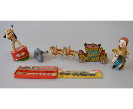 A small group of tinplate and other toys, by Tri-ang and others, mostly unboxed, including a clockwork Schuco Clown with Drum