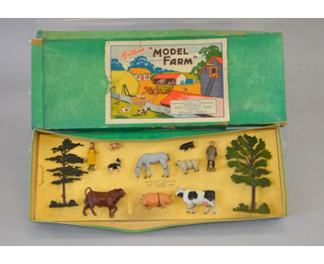 Britains Model Farm No. 154F, comrprising of: farmer; milkmaid; two trees; eight animals. Tied to original backing card (grub
