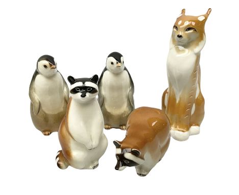 Collection of ceramic USSR animal figures, comprising lynx, two penguins and two raccoons, all with stamped marks beneath, ta