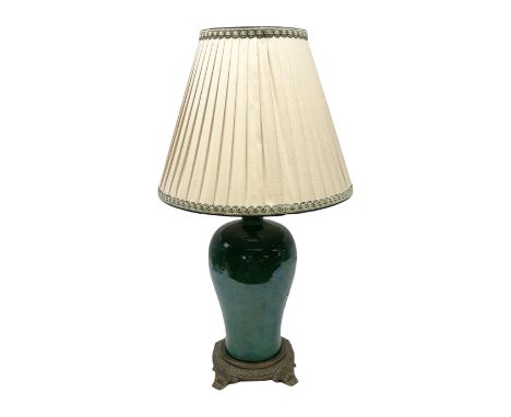 Green baluster form crackle glaze table lamp, with ornate brassed base and pleated fabric shade