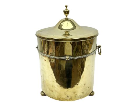 Cylindrical brass coal bucket with lid, raised on three feet, urn finial, H54cm