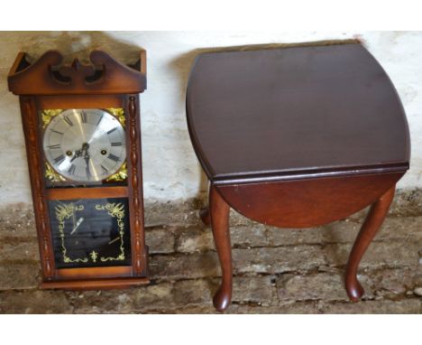 Small mahogany table and a wall clock