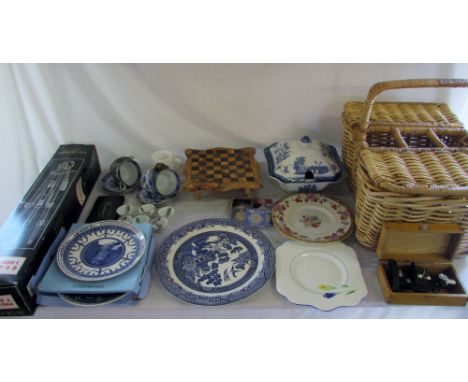 Wicker basket containing various items inc blue and white ceramics, Wedgwood, tripod, microscope, commemorative coins and che