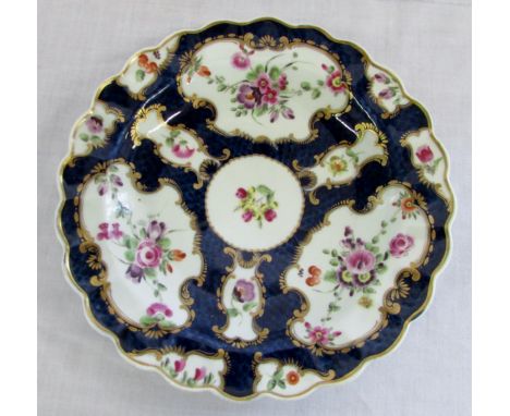 First period Worcester porcelain fluted cabinet plate with floral spays within gilt bordered cartouche &amp; scale blue groun