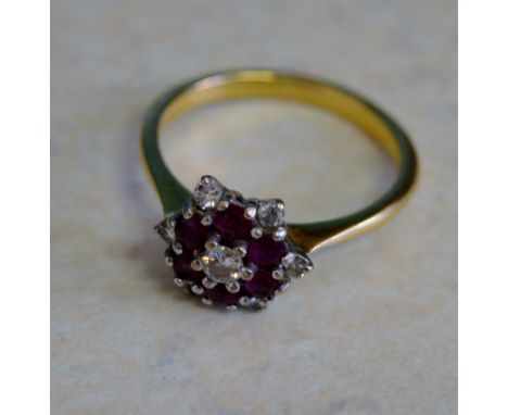 Tested as 18ct gold ruby and diamond ring size O