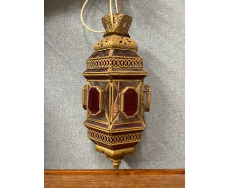 An Eastern style metal and red glass lantern 