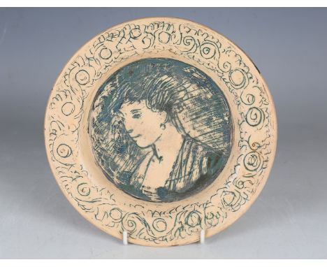 A Quentin Bell Fulham Pottery circular plate, incised and painted in green with a head and shoulders portrait of an elegant l