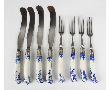 Eight Bow porcelain knife and fork hafts, mid-18th century, each of pistol grip shape, painted in blue with scrolling lambreq