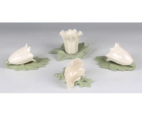 Two Royal Worcester wall pockets, circa 1903 and 1907, each modelled as a white trumpet shaped flower against a backdrop of c