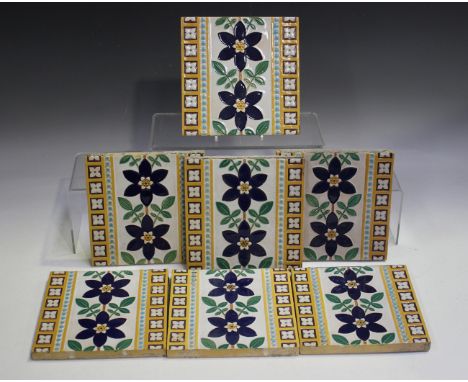 A mixed group of pottery tiles, 19th century, including a set of seven by Minton &amp; Co with stems of blue flowers between 