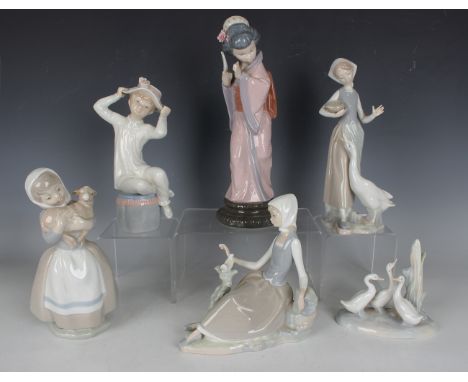 Four Lladro figures, comprising Timid Japanese, No. 4990, Girl with Hat, No. 1147, Shepherdess with Dove, No. 4660, and Girl 