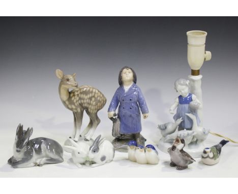 Four Royal Copenhagen models, comprising Boy with Umbrella, circa 1955, No. 3556, height 18cm (second quality), Kid, No. 2648