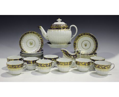 A Coalport porcelain fluted part tea service, late 18th century, with cobalt blue and floral gilt decoration, comprising teap