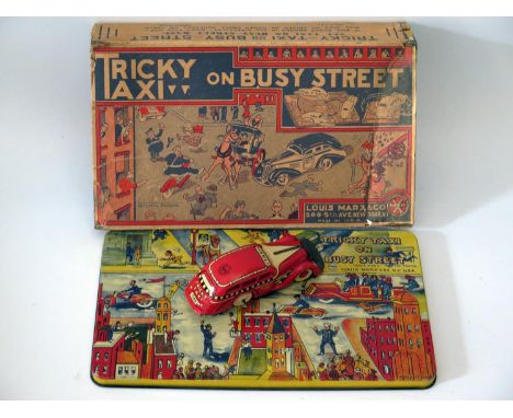 Tin Plate Toy _ A Marx Tricky Taxi on busy street. Manufactured in 1935 and complete with box 